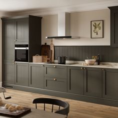 a kitchen with wooden floors and gray cabinets