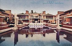 an old photo of a building with water in the foreground