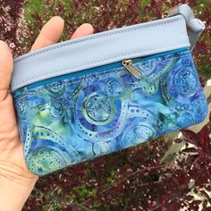 "Wallet, Clutch,or Phone case in Sky Blue Italian Leather paired with a pretty Boho Paisley Batik.This bag can carry your essentials and be your only bag-or use it in your big purse as I do for a wallet. Front zip works for change and top zip opens main section which fits dollar bills. There's also a small inside pocket that holds credit cards. Nice to carry jewelry when traveling. Or for your 7\" Knitting Needles and Crochet Hooks. 7 1/2\" wide 4 3/4\"deep PLEASE NOTE BATIK VARIES SLIGHTLY Matc Blue Zipper Pouch Clutch For Daily Use, Blue Clutch With Zipper Pouch For Daily Use, Handmade Blue Pouch Wallets, Blue Wallets With Removable Pouch As Gift, Blue Rectangular Coin Purse With Removable Pouch, Blue Mobile Phone Bag Clutch As Gift, Blue Wallet With Removable Pouch As Gift, Blue Rectangular Wallet With Mobile Phone Bag, Blue Clutch Mobile Phone Bag As Gift