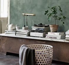 a coffee table with books and plants on it