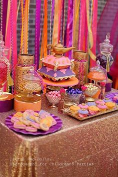 a table topped with lots of different types of desserts and candies on top of it