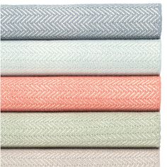 four different colored fabrics stacked on top of each other