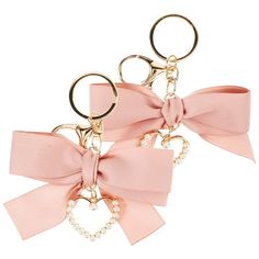 two pink bows with pearls on them are attached to the handles of each keychain