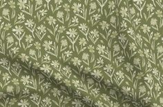 a green and white flowered fabric with small flowers on the side, it is very soft