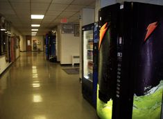 an empty hallway with two vending machines in it