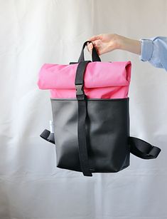 Introducing the Roll Top Backpack - the perfect combination of style and functionality! Crafted from high-quality vegan leather, cordura material and cotton lining. Can be used as everyday backpack, travel backpack or diaper backpack.  The Black faux leather and pink cordura material gives the backpack a sophisticated and modern look. The roll-top design allows for easy access and ensures that all your belongings are safely secured inside. Whether you're commuting to work, traveling or simply running errands, this backpack has you covered. With plenty of storage space, you can easily carry your laptop, books, wallet, phone, and any other essentials you need for the day. *  100% vegan and cruelty free. *  Strong Faux leather (vegan leather), Cordura material, Cotton lining *  High-quality w Corduroy Backpack, Portfolio Bag, Everyday Backpack, Colorful Backpacks, Backpack For Women