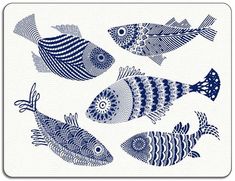 four blue and white fish are shown on a white square coaster with an intricate design