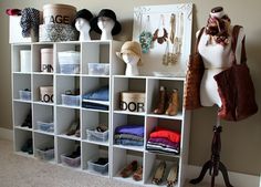 a white shelf filled with lots of different types of hats and purses on top of it