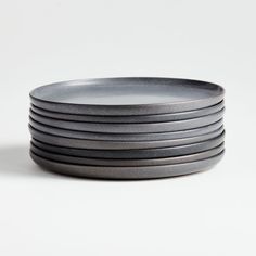 a stack of grey plates sitting on top of each other