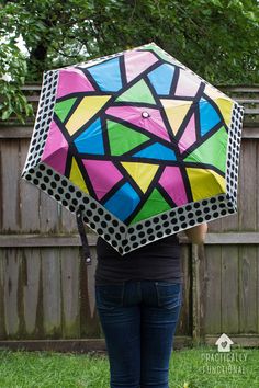 a woman is holding an umbrella in her hand and she has the shape of a diamond on it