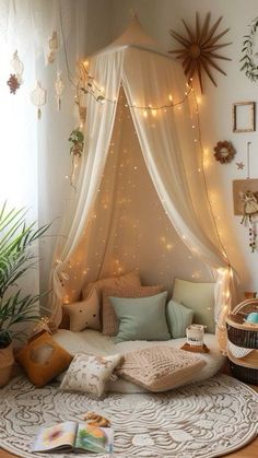 a room with a bed covered in lights and pillows on the floor next to a potted plant