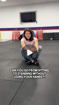 a woman squatting on the floor in front of a tv screen with words above her reading can you go from sitting to standing without using your hands?