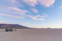 a car is parked in the middle of an empty desert