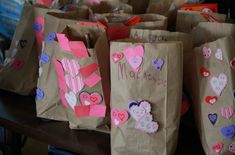 many bags are decorated with hearts and handwritten words