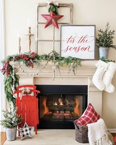 a fireplace decorated with christmas decorations and stockings