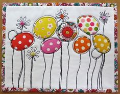 an embroidered artwork with flowers and polka dots