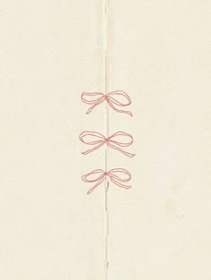 a drawing of three red bows on a piece of paper with string attached to it