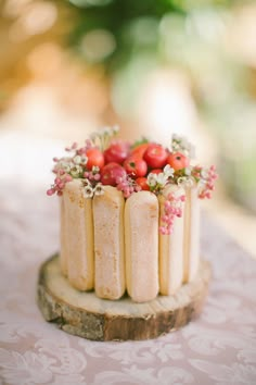 a small cake decorated with flowers and berries