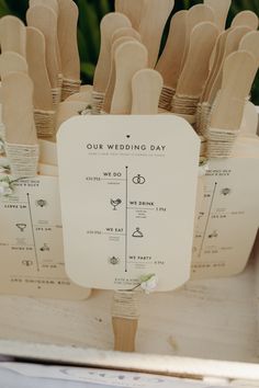 a bunch of wooden utensils sitting on top of a white box with the words our wedding day written on them