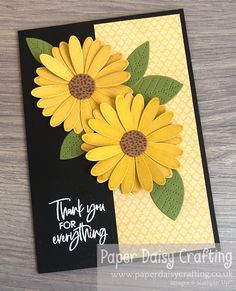 a close up of a card with yellow flowers on the front and back of it