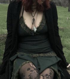 a woman with red hair sitting on a bench wearing tights and stockings, looking at the camera