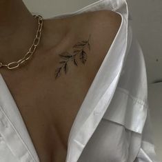 the back of a woman's neck with leaves on it