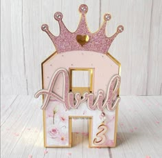 a pink and gold birthday card holder with a crown on top