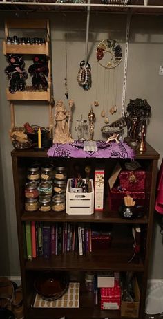 a book shelf filled with lots of books and knickknacks on top of it