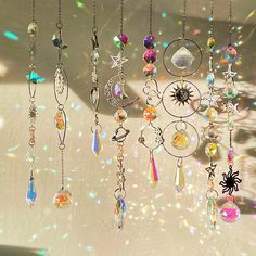 the sun is shining brightly through the glass beads and chains hanging from the ceiling in the room