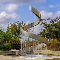 a water fountain with a spiral design in the middle