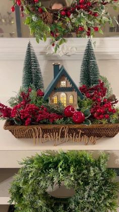 two christmas wreaths with red flowers and evergreen trees