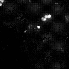 black and white photograph of the night sky with small dots in it's foreground