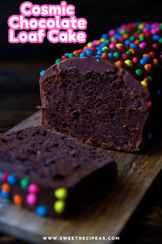 a chocolate loaf cake with sprinkles on it and the words cosmic chocolate loaf cake