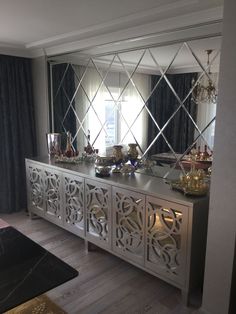 an image of a room that has been decorated with mirrors and other things on it