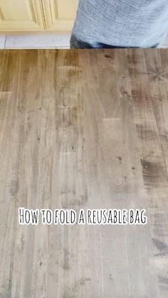 a wooden floor with the words how to fold a reusable bag on it