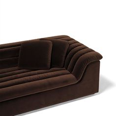 a brown couch sitting on top of a white floor