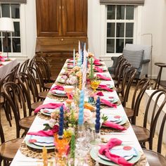 a long table set with place settings for dinner