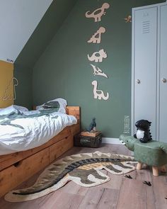 a bedroom with green walls and wooden floors