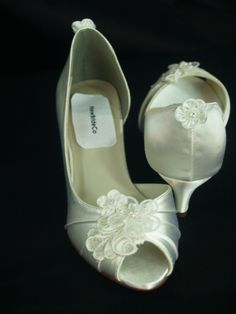 a pair of white shoes with flowers on them