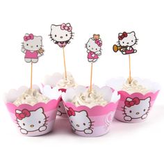 hello kitty cupcakes with toppers on sticks in pink and white paper cups