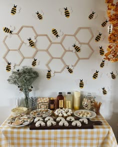 a table topped with cookies and honeycombs on top of a checkered table cloth