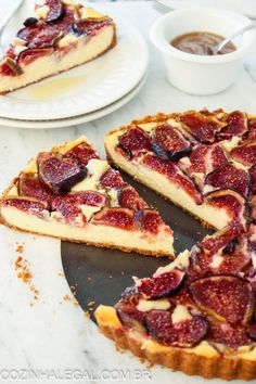 a cheesecake topped with sliced figs on top of a table