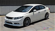 a white car parked in front of a building