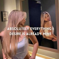 a woman standing in front of a mirror with the caption, absolutely everything i desired is already mine