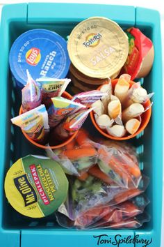 a blue plastic container filled with food and condiments