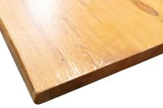 a close up view of a wooden table top with no wood grains on it