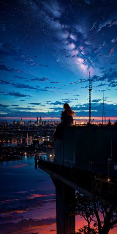 a person sitting on top of a roof looking at the stars in the night sky