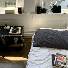 a bedroom with a bed, nightstands and an open book on top of it