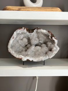 a large piece of rock sitting on top of a white shelf