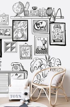 a black and white wall with many different pictures on it, including a chair in the foreground